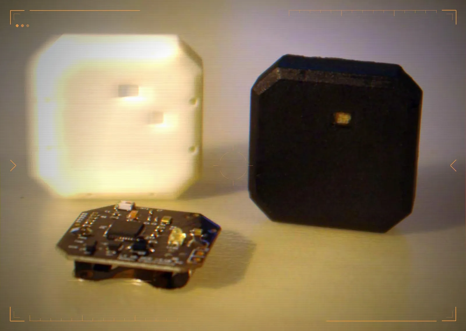 A sensor board with its 3D-printed housing and the finished sealed unit