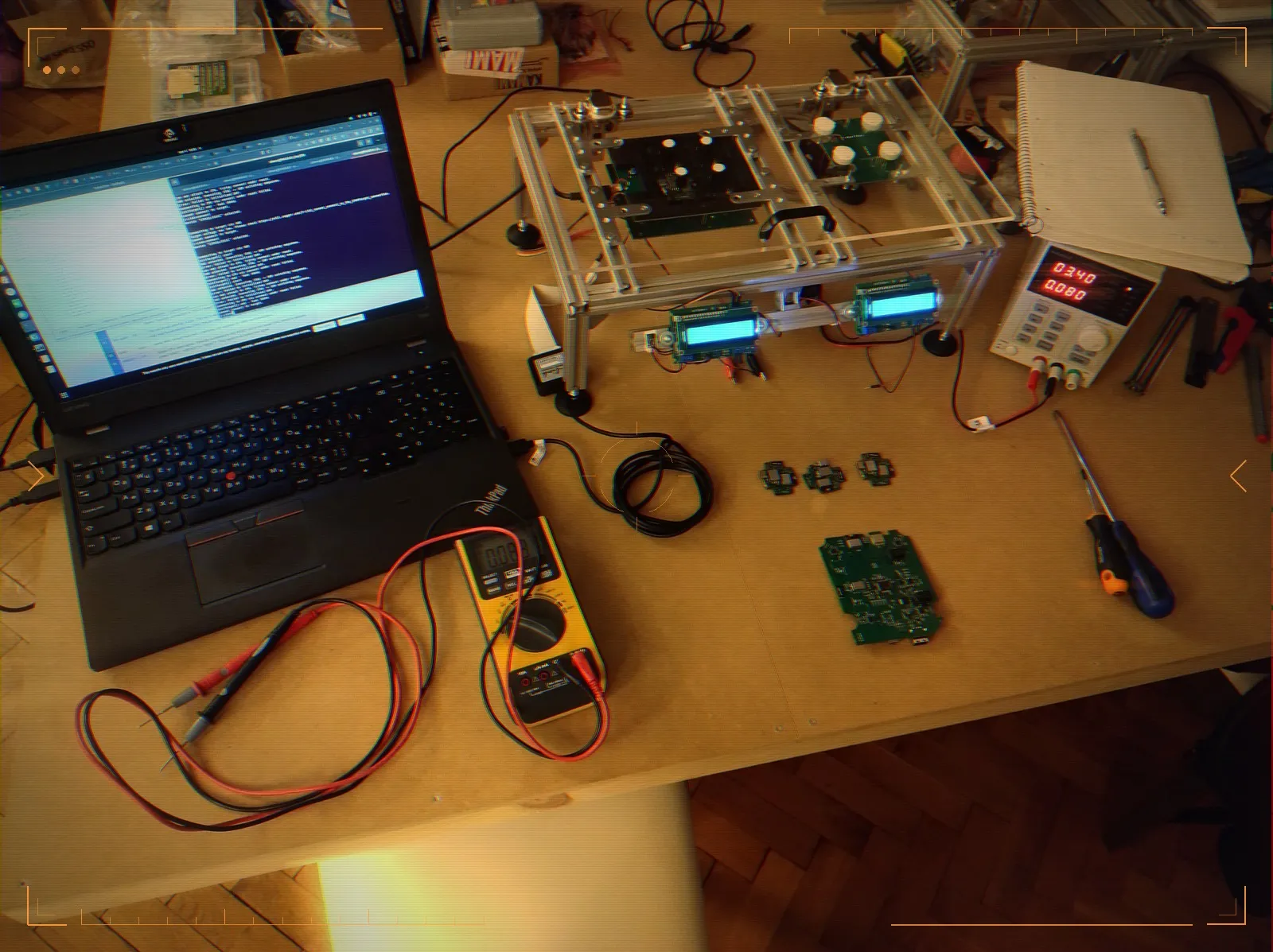 The test station on the bench — jig, controllers, and instruments