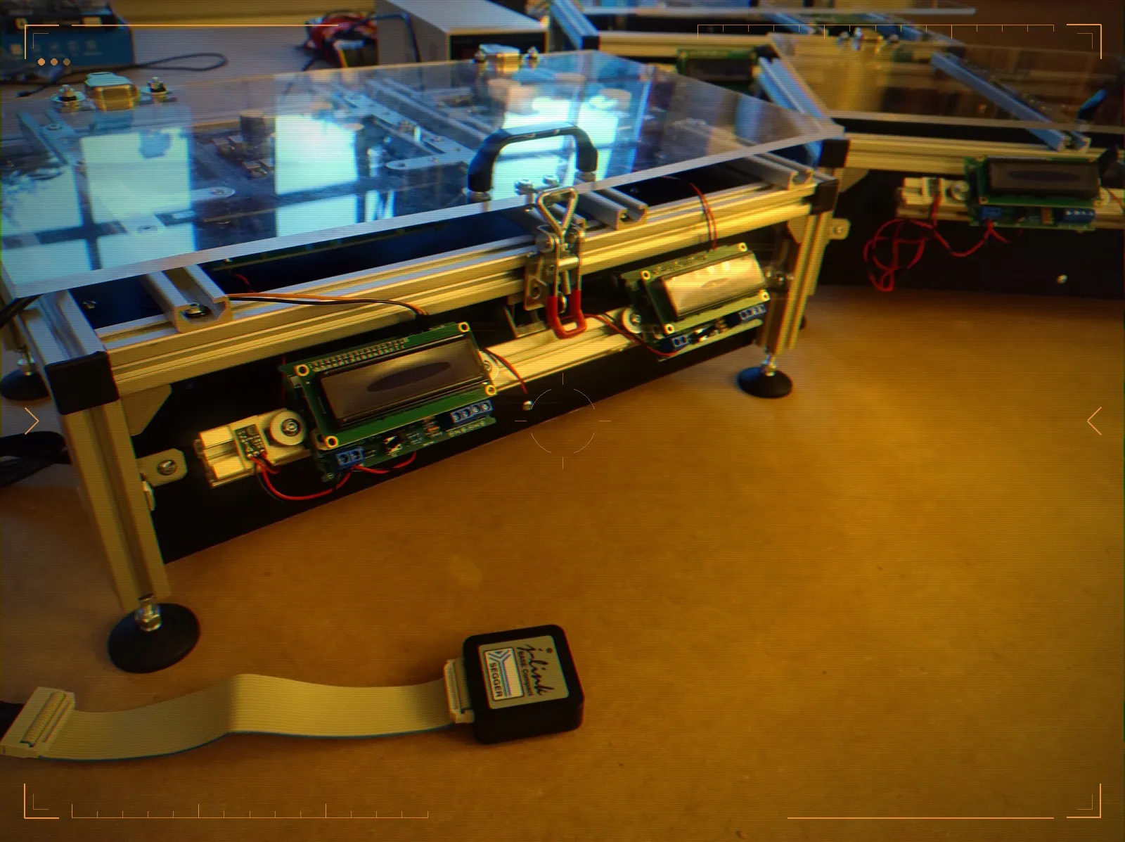 The finished tester — an acrylic and aluminium fixture with a clamping lid